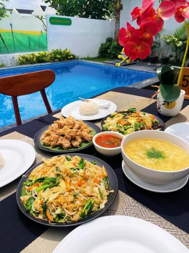 a table with plates of food and bowls of soup at D'svarga Glamping in Seturan