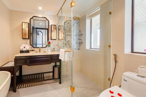 a bathroom with a sink and a shower at Laluna Hoi An Riverside Hotel & Spa in Hoi An