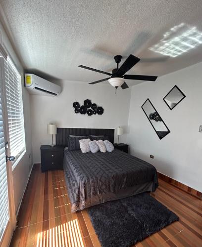 a bedroom with a bed and a ceiling fan at Estudio práctico y confortable en segundo piso in Senecú