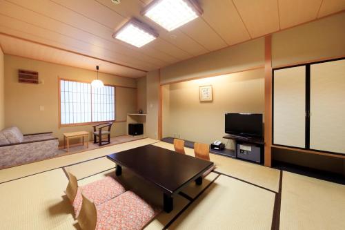 a living room with a table and a couch at Aishinkan in Morioka