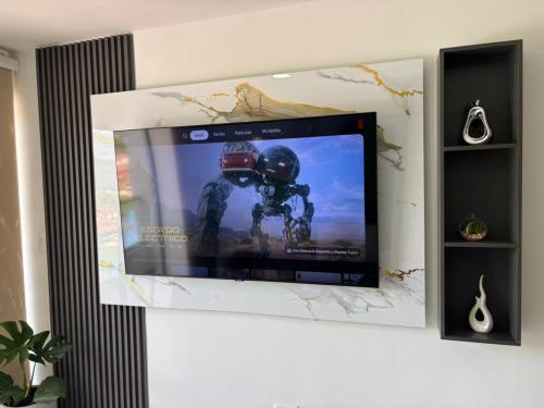 a flat screen tv hanging on a wall at Full Apartamento de descanso vacacional in San Gil