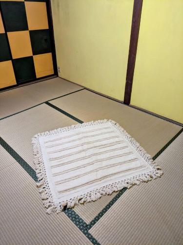 a white rug on the floor of a room at Men only B&B KegonFalls in Nikko