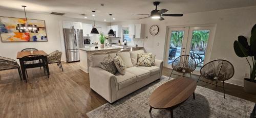 a living room and kitchen with a couch and a table at Family Pool Home Close to Naples' Best Beaches in Naples