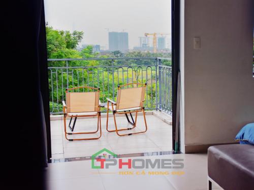 two chairs sitting on a balcony with a view at TP-HOMES in Ho Chi Minh City