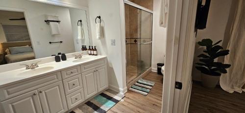 a white bathroom with a shower and a sink at Family Pool Home Close to Naples' Best Beaches in Naples