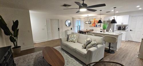 a living room with a couch and a kitchen at Family Pool Home Close to Naples' Best Beaches in Naples