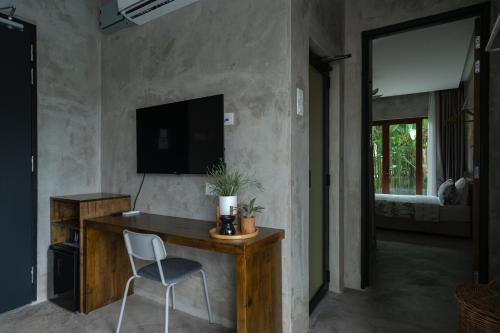 a room with a desk with a chair and a television at Chrisenbel Hideaway Retreat in Petaling Jaya