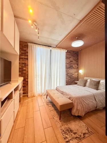 a bedroom with a bed and a large window at Loft en el Centro de Monterrey, Hermosas vistas FIFA World Cup 2026 Fan Fest Lodging in Monterrey
