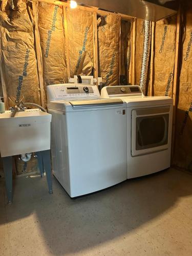 two washing machines and a sink in a room at quiet and comfortable in Cleveland