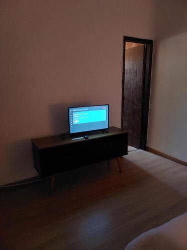 a television sitting on a table in a room at Pousada Jardim Alterosa in Vespasiano