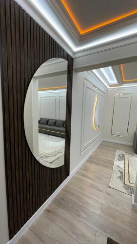 a mirror on a wall with a couch in a room at квартира in Taraz