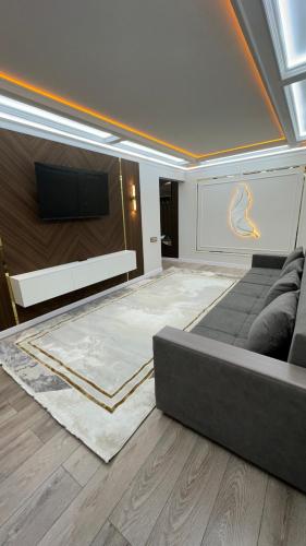 a living room with a couch and a flat screen tv at квартира in Taraz