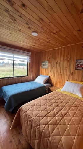 Ένα ή περισσότερα κρεβάτια σε δωμάτιο στο Panguipulli Cabañas Los Tallos