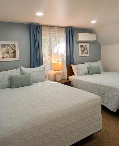 a bedroom with two beds and a window at Beautiful Bar Harbor House in Bar Harbor