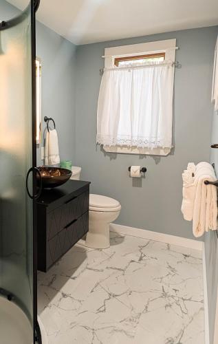 a bathroom with a toilet and a shower at Beautiful Bar Harbor House in Bar Harbor