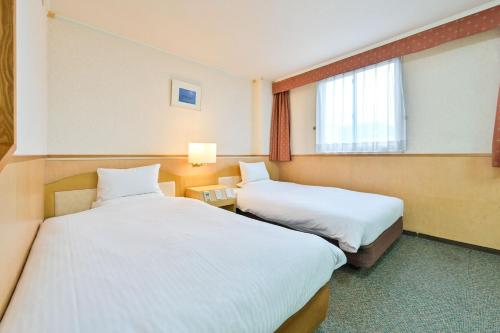 Postel nebo postele na pokoji v ubytování Central Hotel Sasebo