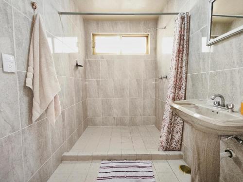 a bathroom with a shower and a sink at Cozy bedroom at 5 min Mexico City Airport T1 & T2 in Mexico City