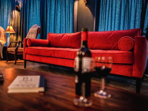 a living room with a red couch and a table at Moorlands in Chilcompton