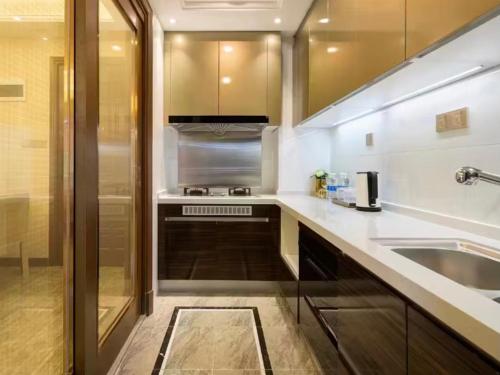 a kitchen with a sink and a stove at Fsmile Viessmann City Resort Suites in Chongqing
