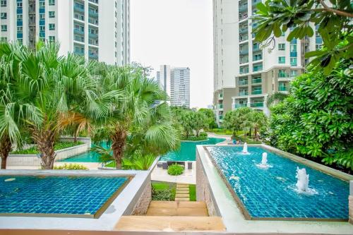 a pool in the middle of a city with tall buildings at Belle Grand Rama 9 Bangkok in Bangkok