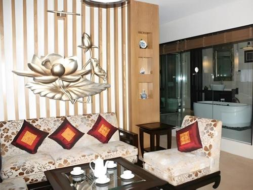 a living room with a couch and a table at BMC Ha Tinh hotel in Ha Tinh