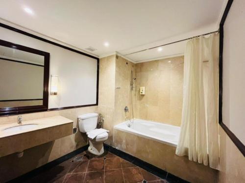 a bathroom with a tub and a toilet and a sink at Kingston Hotel 9 - Jonker Street Malacca in Kampong Morten
