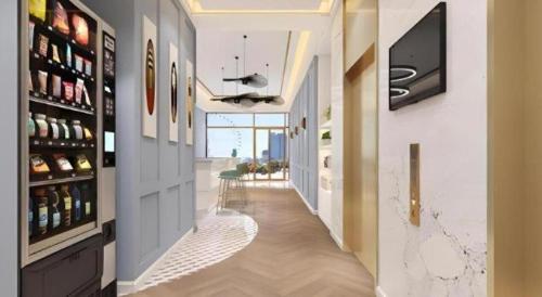 a hallway of a home with a tv on a wall at Magnotel Hotel Suzhou Guanqian Street Pingjiang Road in Suzhou