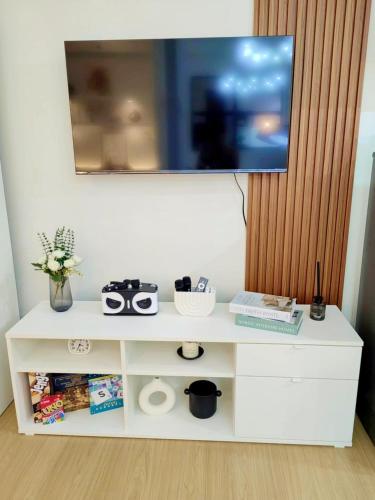 a white cabinet with a tv on top of it at THE IVORY STAYCATION suite at Hope Residences Trece Martires Cavite in Bitangan