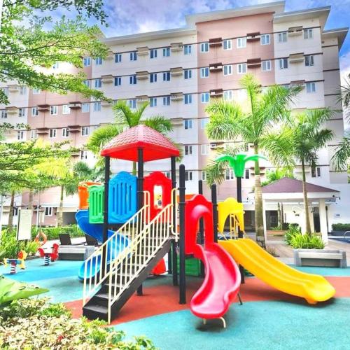 a playground at a hotel with a slide at THE IVORY STAYCATION suite at Hope Residences Trece Martires Cavite in Bitangan