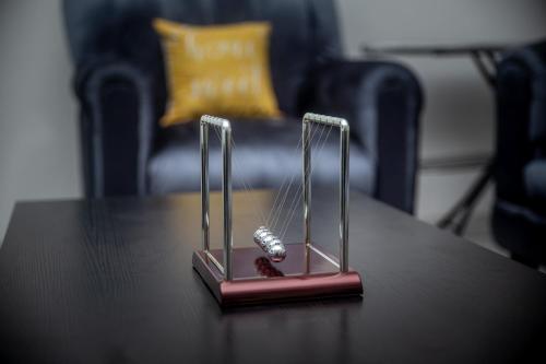a trophy on a table with a watch on it at The Willows Apartment in Kumasi