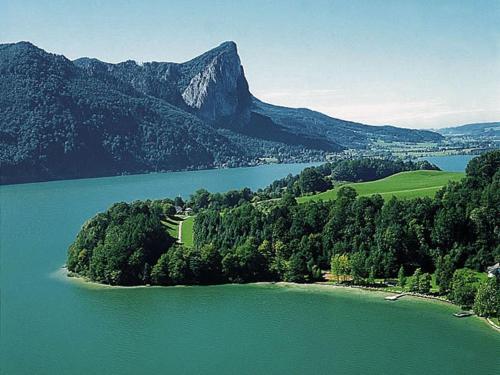 an island in the middle of a large body of water at Hotel Seehof in Loibichl