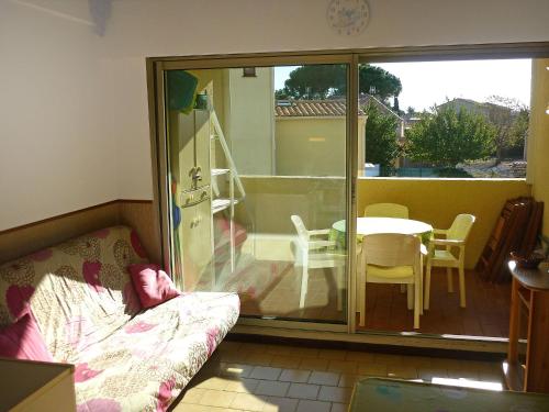 a living room with a sliding glass door to a balcony at Apartment RÃ©sidence Marine in Le Grau-dʼAgde