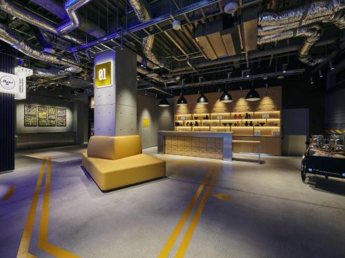 a show room with a yellow couch and a table at ibis Styles Nagoya in Nagoya