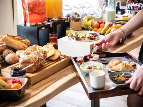 a buffet with a bunch of food on a table at Novotel Megève Mont-Blanc in Megève