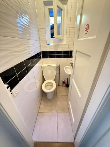 a small bathroom with a toilet and a sink at Rooms for rent in Bolligen in Bolligen
