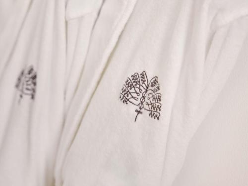 a drawing of a tree on a white shirt at Raffles Al Areen Palace Bahrain in Manama