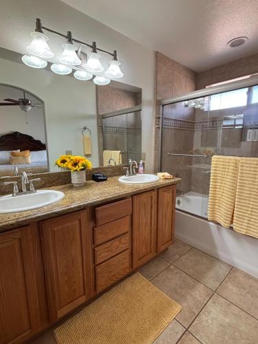 a bathroom with two sinks and a shower at New Lux Sunflower House in Joshua Tree
