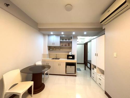 a small kitchen with a table and chairs in a room at Touristation @ Crowne Bay Tower in Manila