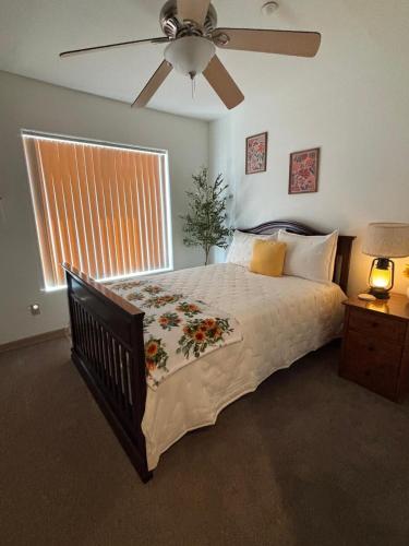 a bedroom with a large bed with a ceiling fan at New Lux Sunflower House in Joshua Tree