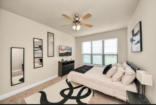 a bedroom with a bed and a ceiling fan at Luxury Estate in Houston