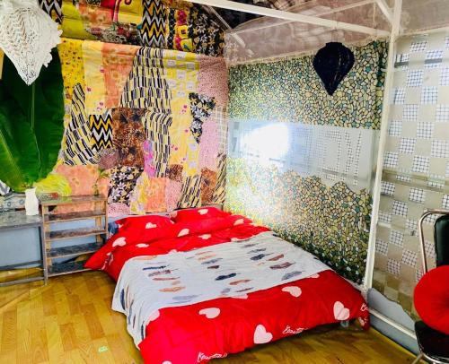 a bedroom with a bed with red pillows on it at Chill Door Homestay in Ấp Long Ðại