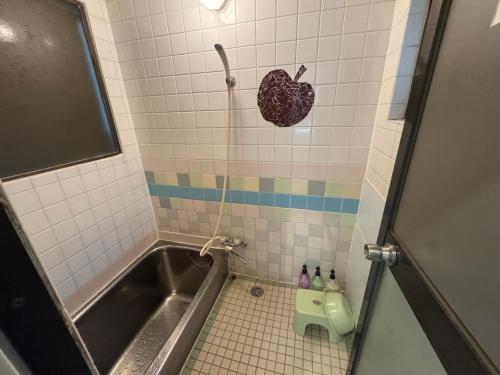 a bathroom with a shower with a heart on the wall at ホテル亀岡 in Minamijō