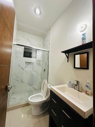 a bathroom with a shower and a toilet and a sink at Atlántico departamento in Mazatlán