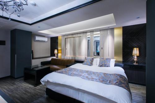 a hotel room with a bed and a couch at HOTEL Luana in Kitakyushu