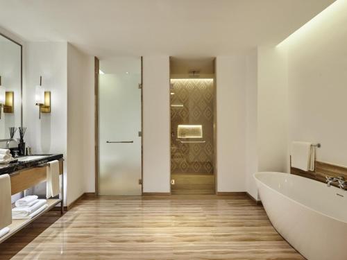 a bathroom with a tub and a sink and a bath tub at Fairmont Taghazout Bay in Taghazout