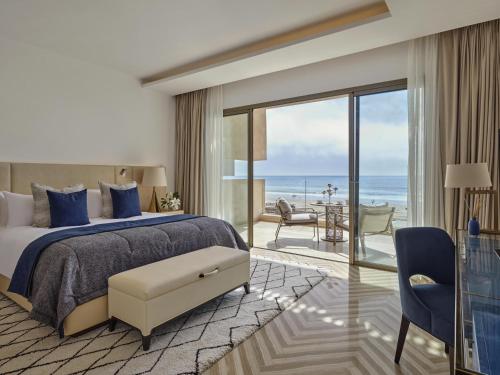 a bedroom with a bed and a view of the ocean at Fairmont Taghazout Bay in Taghazout