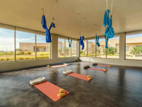 a yoga room with a bunch of yoga mats at Fairmont Taghazout Bay in Taghazout