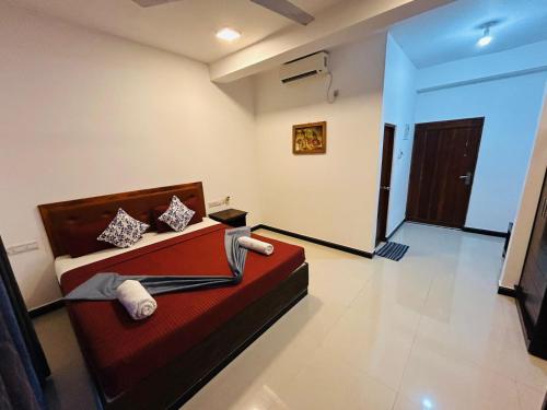 a room with a red couch in a room at Amelia Resort in Sigiriya