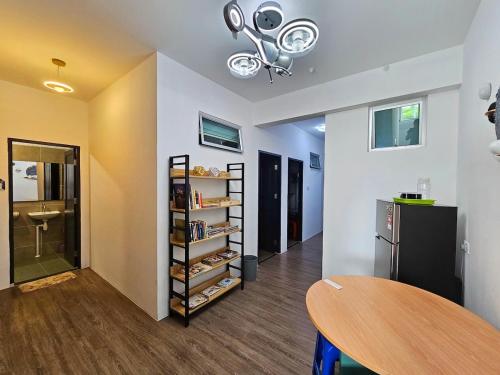 a room with a table and a shelf with items at Astronaut Riverview Kuching Homestay in Kuching