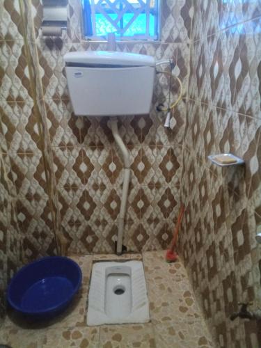a small bathroom with a toilet in the floor at Keroka Luxury Apartment in Keroka